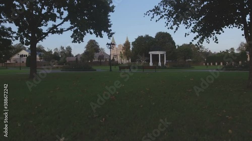 White Rotunda and St. Archangel Michael Church in Sirvintos in the Evening. Aerial Low Track Left photo