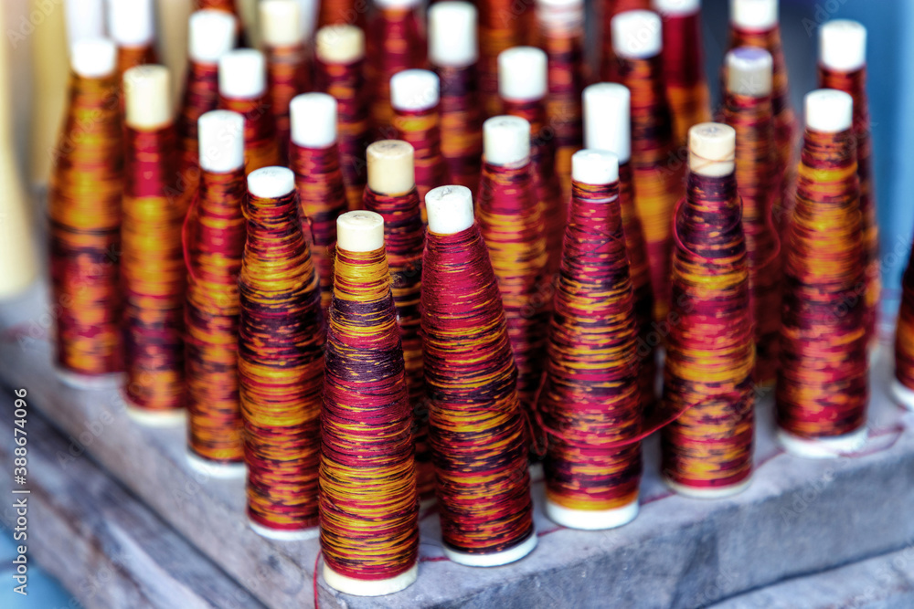 colors of the dyed silk threads in the tube to use in weaving mudmee cloth in Thailand. colors of the dyed silk threads in the tube to use in weaving mudmee cloth in Thailand.