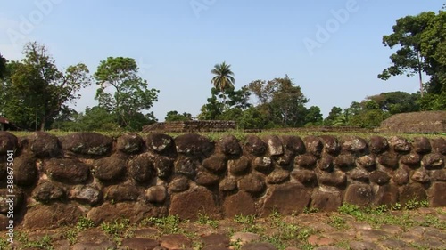 Stone wall inside of the Izapa archeological site in Mexico.Group F pyramids in the background. photo