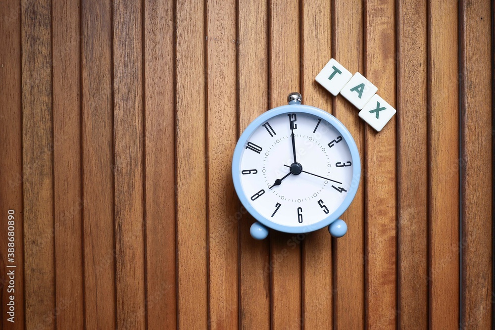 Block letters and alarm clock on wooden table Block letters and alarm clock on wooden table