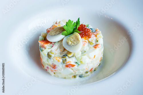 Russian traditional salad Olivier, isolated on white.