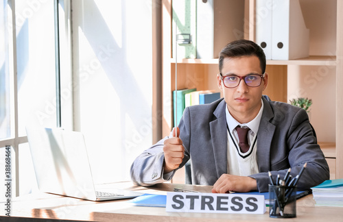 Stressed young male teacher...