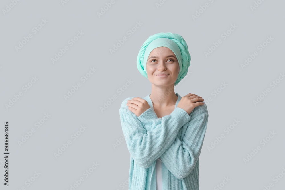 Optimistic woman after chemotherapy on grey background Optimistic woman after chemotherapy on grey background