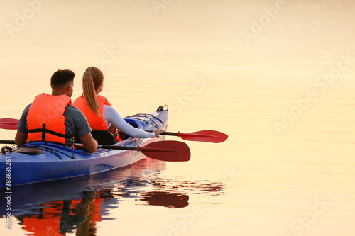 Young couple kayaking in river