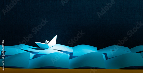 Paper ship in the paper sea. Concept of the theme of bureaucracy.