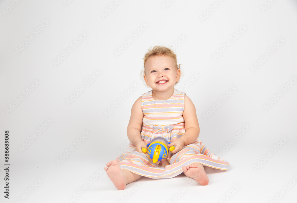 little girl with curly hair on a light background little girl with curly hair on a light background
