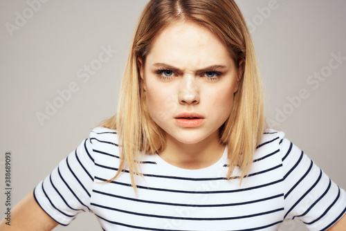 Emotional blonde woman in striped t-shirt lifestyle facial expression close-up © SHOTPRIME STUDIO