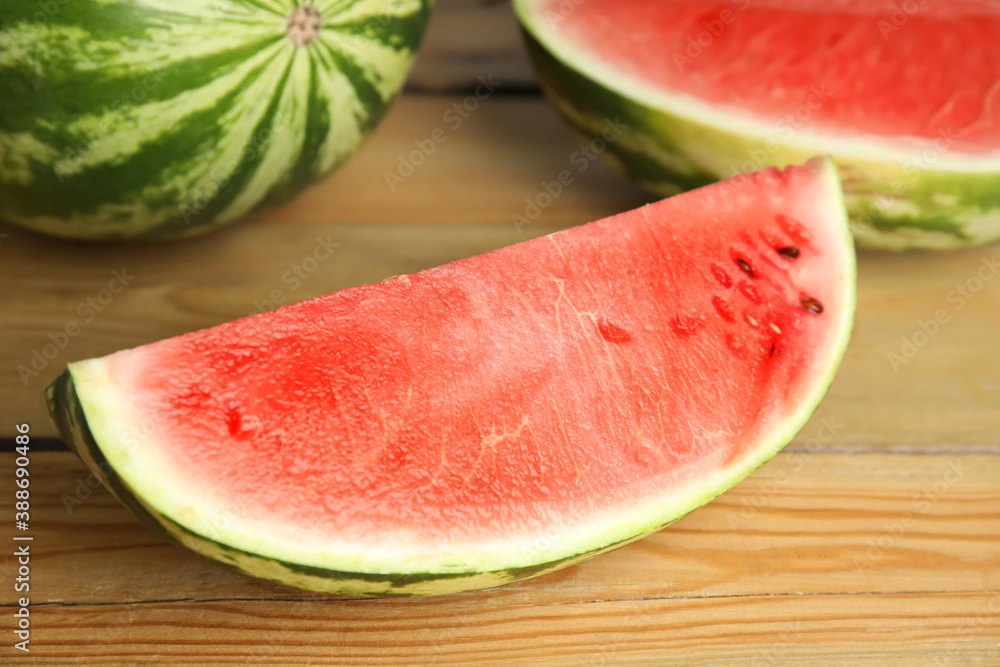 Yummy watermelon slice on wooden table, closeup Yummy watermelon slice on wooden table, closeup