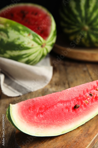 Yummy watermelon slice on wooden table, closeup