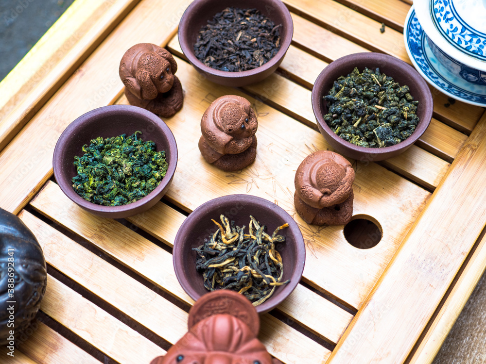 Assortment of Chinese tea, clay mugs on wooden table Assortment of Chinese tea, clay mugs on wooden table