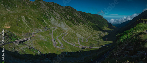 Epic winding road on Transfagarasan pass in Romania in summer time, with twisty road rising up. Road crossing Fagaras mountain range, noted as one of the best motorable roads in the world.