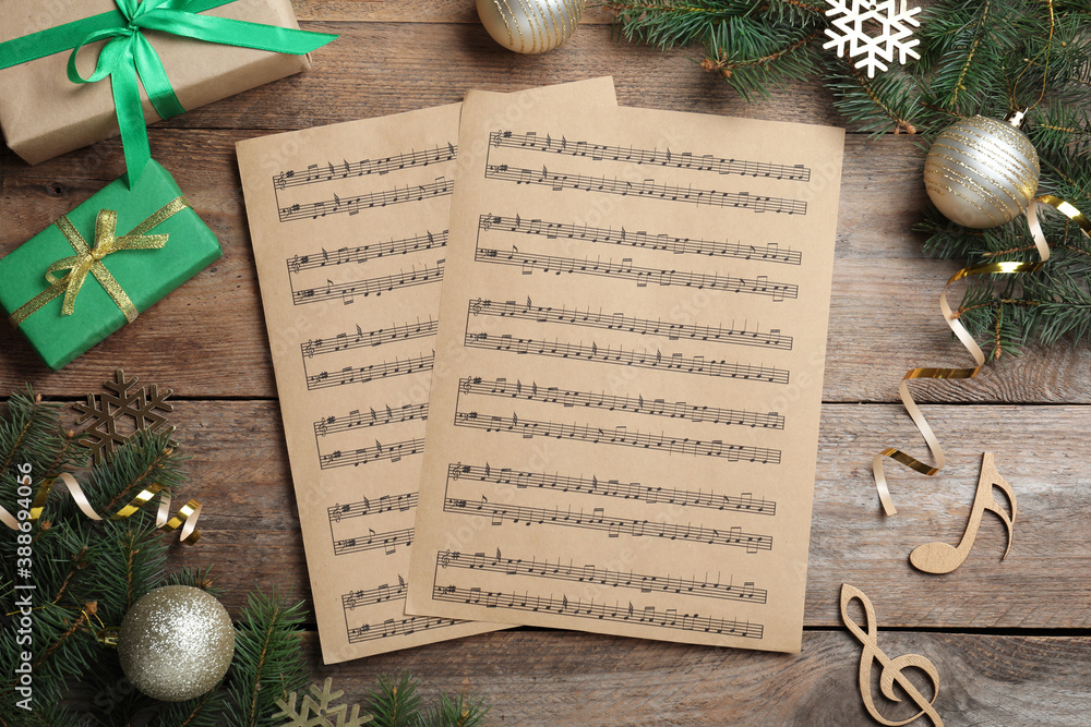 Flat lay composition with Christmas music sheets on wooden background - obrazy, fototapety, plakaty 