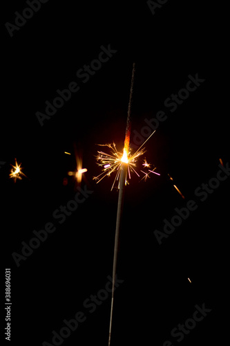 sparkler burning on a black background. new Year