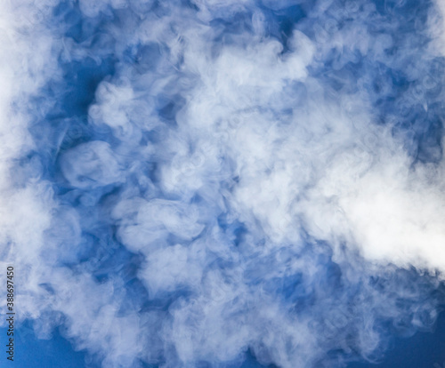 Realistic dry ice smoke clouds fog overlay on dark blue background