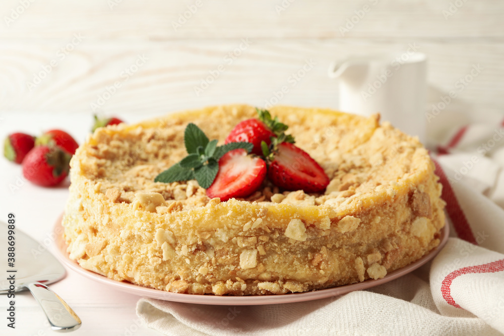 Plate with Napoleon cake with strawberry on white wooden background Plate with Napoleon cake with strawberry on white wooden background