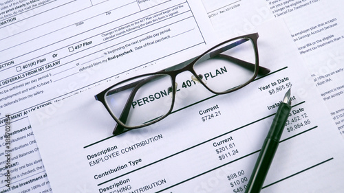 Pension savings. Glasses and pen are on the background sheet Personal 401k plan. Close-up, zoom in shot photo