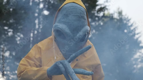 alien in yellow suit is dancing . close up. concept of UFO,space-themed costume party,