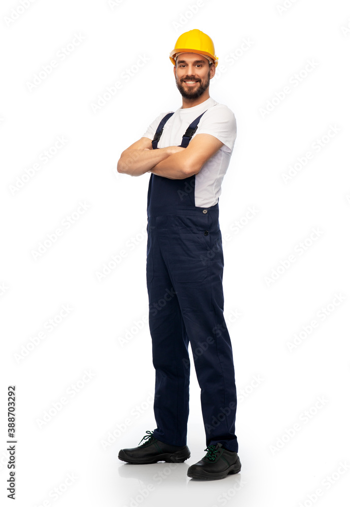 profession, construction and building - happy smiling male worker or builder in yellow helmet and overall with crossed arms over white background profession, construction and building - happy smiling male worker or builder in yellow helmet and overall with crossed arms over white background
