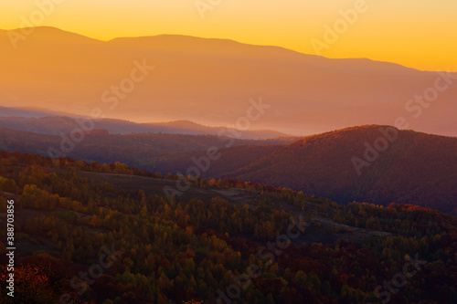 rising clouds in mountainous countryside at sunrise. gorgeous view of autumn fog in valley © Pellinni