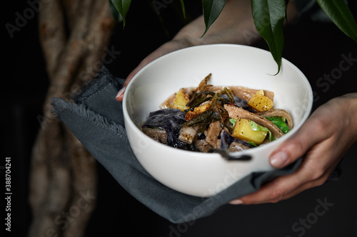 pasta pizzoccheri with chinese cabbage, potato on dark background. italian traditional dish photo