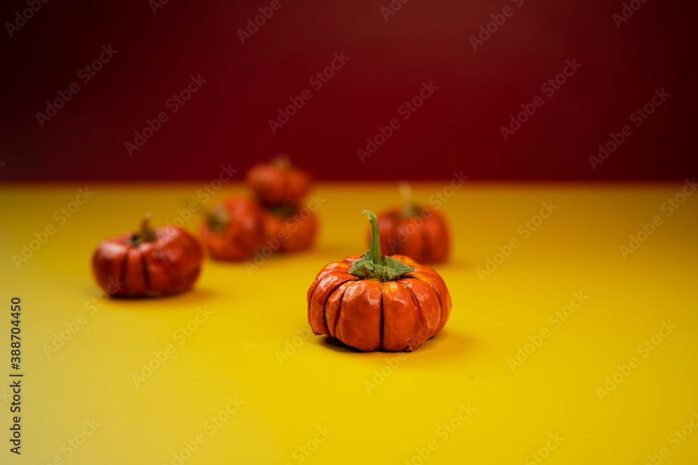 Group of little pumpkins over yellow surface