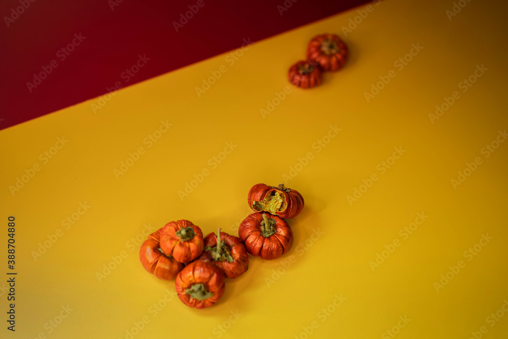 Group of little pumpkins over yellow surface