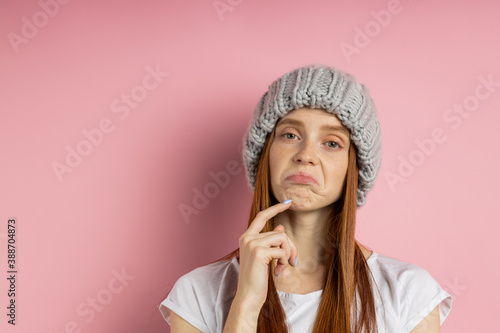 No idea. Hesitant redhead cute young woman with freckled skin looking with uncertain and confused expressions, gesturing. Closeup of careless frivolous girl over pink background.