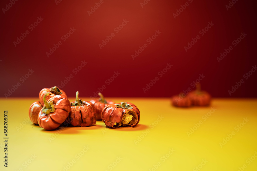 Group of little pumpkins over yellow surface