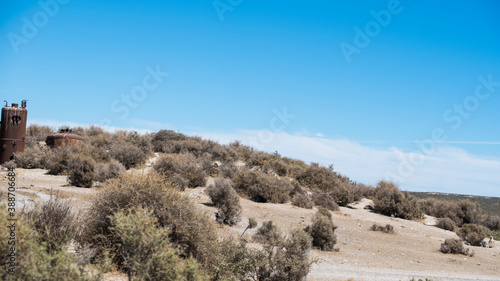 Beautiful example of the empty street and the desert in north Patagonia region of Valdes district in Puerto Madryn, Argentina. Typical patagonian ranch and farm life in South America.