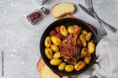 Homemade lunch roasted pork shank with potatoes. meat recipe photo