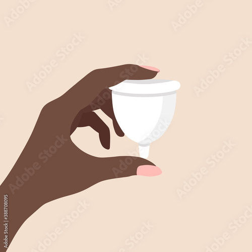 Hand holding woman menstrual cup