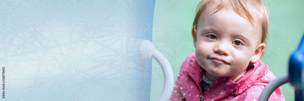 Cute baby girl having fun on a playground; panoramic banner Cute baby girl having fun on a playground; panoramic banner