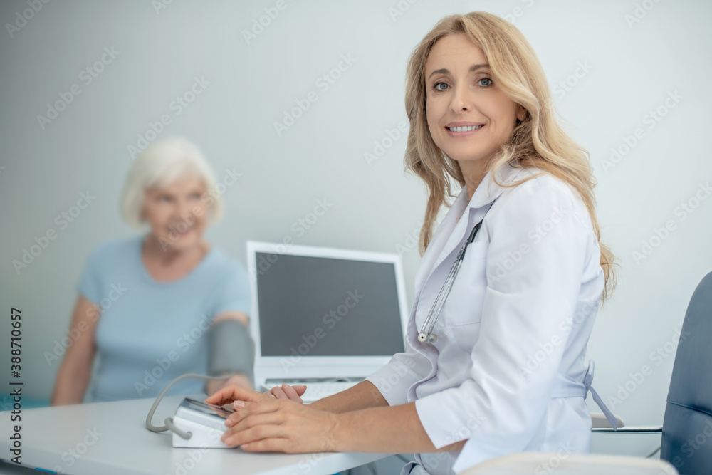 Fair-haired young doctor consulting an elderly patient Fair-haired young doctor consulting an elderly patient
