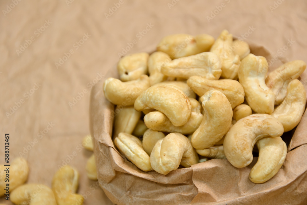 Cashew nuts. Cashew kernels. Clean organic nuts on retro paper background. Organic healthy food. Cashew nuts. Cashew kernels. Clean organic nuts on retro paper background. Organic healthy food.