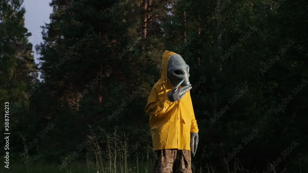 custom made wallpaper toronto digitalalien in yellow suit stands in forest and looks around, sunbeam and sunset, UFO concept, space, alien.