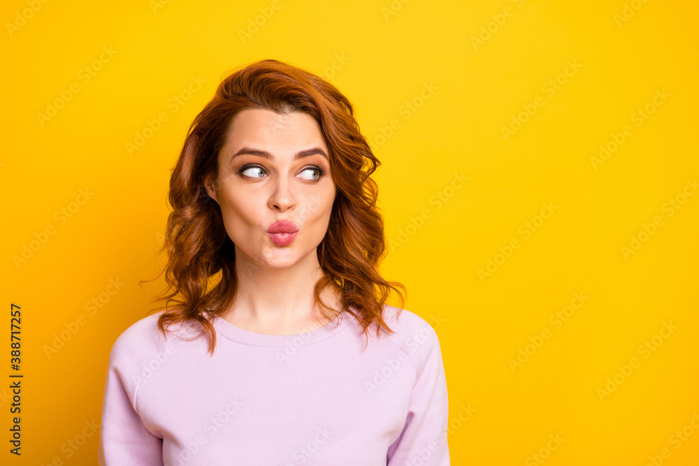 Closeup photo of beautiful pretty ginger lady looking empty space sending air kisses boyfriend shy person avoid eyes contact wear pink sweater shirt isolated yellow color background Closeup photo of beautiful pretty ginger lady looking empty space sending air kisses boyfriend shy person avoid eyes contact wear pink sweater shirt isolated yellow color background