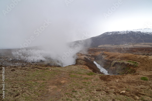 Hiking in the wild and dramatic nature of volanoes, snowy mountains, waterfalls, geysers and hot springs in Iceland