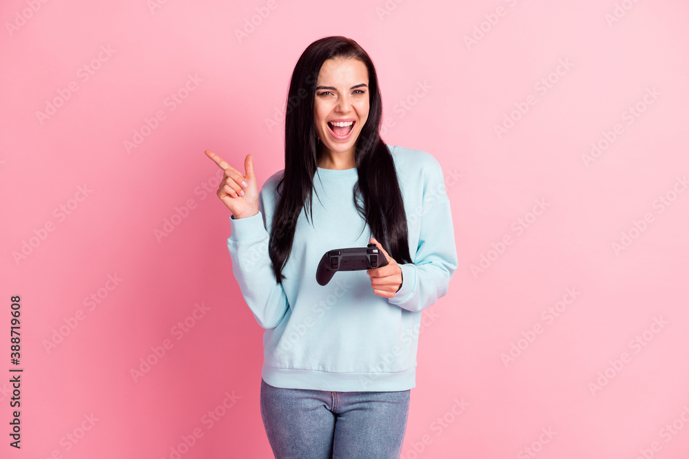 Photo of addicted gamer lady hold joystick playstation wear blue pullover jeans isolated pink color background Photo of addicted gamer lady hold joystick playstation wear blue pullover jeans isolated pink color background