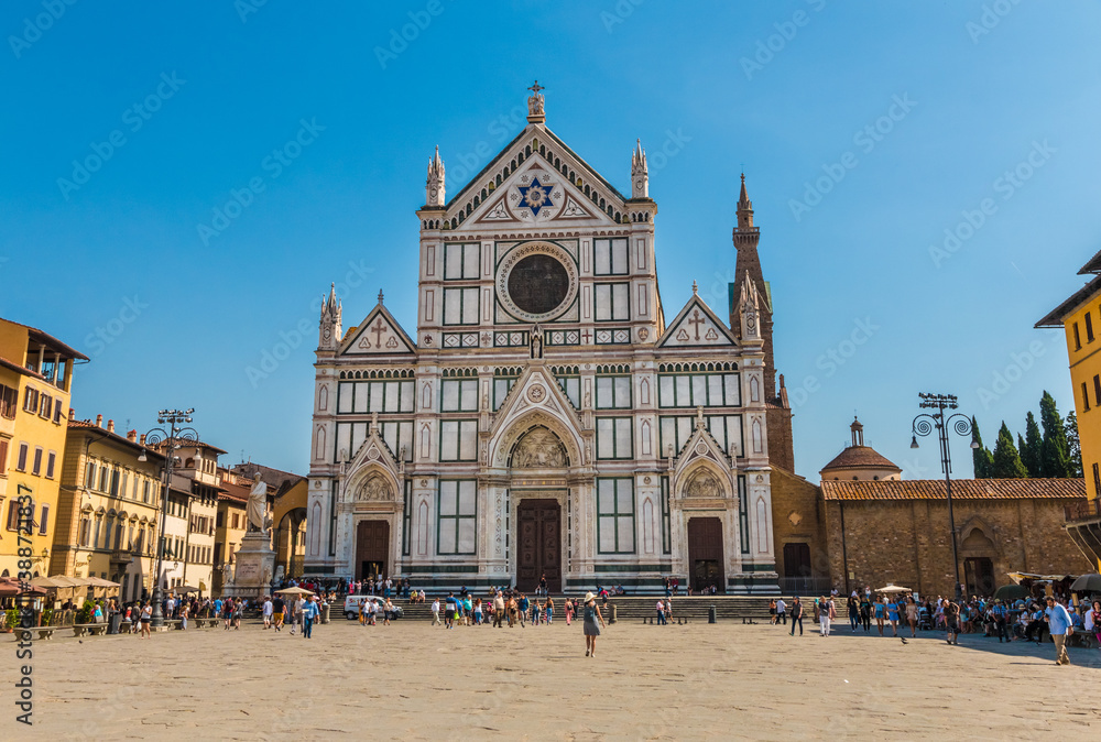 Lovely view of the Basilica di Santa Croce (Basilica of the Holy Cross) in Florence. The Neo-Gothic style facade of the church with three cusps and a David's star is covered with bichrome marbles.