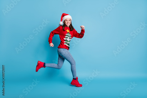 Full body size profile photo of cute pretty cute lady run wave hands wear santa x-mas headwear red ornamented sweater jeans boots isolated blue color background