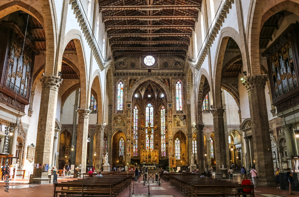 Lovely view from the nave to the transept, chancel and apse with the main chapel inside the famous Basilica of Santa Croce in Florence, Tuscany, Italy.