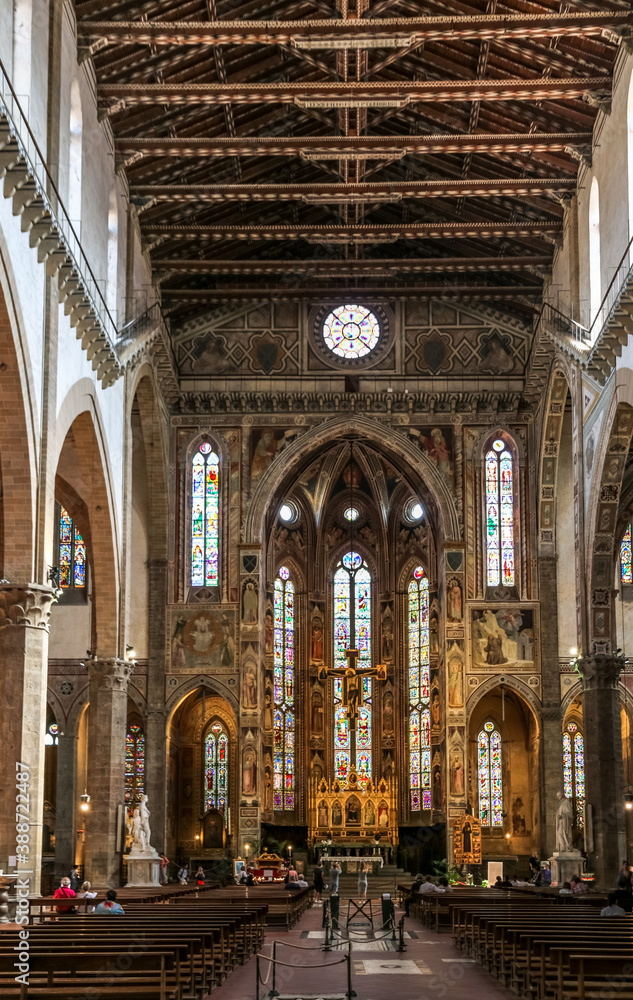 Great portrait shot from the nave to the transept, chancel and apse with the main chapel inside the famous Basilica of Santa Croce in Florence, Tuscany, Italy.