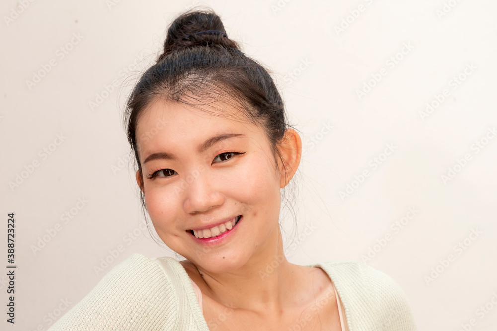 young beautiful and happy Asian Chinese woman with hair bun gesturing and smiling cheerful isolated on studio background young beautiful and happy Asian Chinese woman with hair bun gesturing and smiling cheerful isolated on studio background