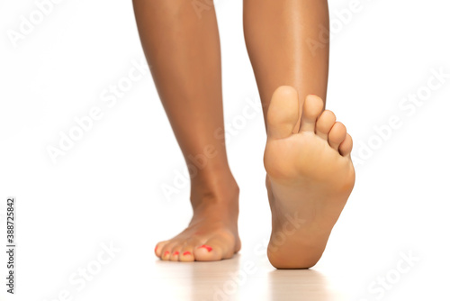 Woman's bare feet isolated on white background.