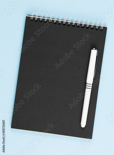 open black notebook on blue table