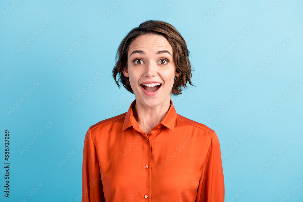 Closeup photo of attractive pretty funky lady bob hairdo good mood cute appearance open mouth listen amazing great news wear orange office shirt isolated blue pastel color background Closeup photo of attractive pretty funky lady bob hairdo good mood cute appearance open mouth listen amazing great news wear orange office shirt isolated blue pastel color background