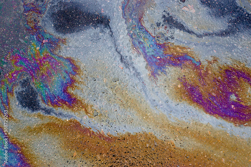 Oil slick on the asphalt road background