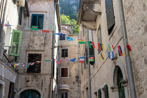 Montenegro - Flags of the various states decorating a narrow street in Kotor Old Town