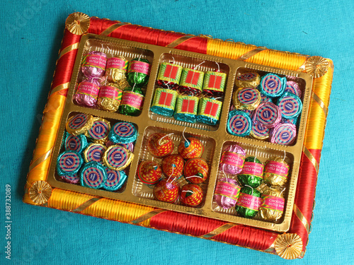Diwali celebrations with fire crackers shaped homemade chocolates inside a gift box