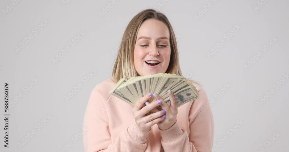 The girl rejoices at the money she received The girl rejoices at the money she received